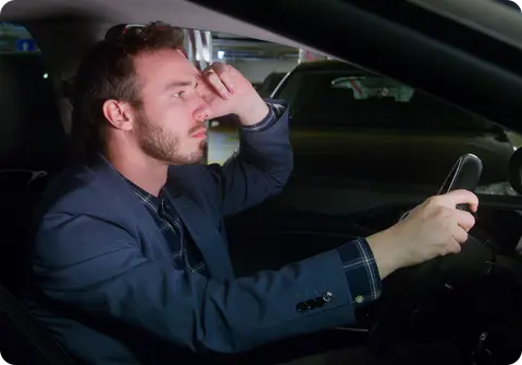 Frustrated driver searching for a free parking space